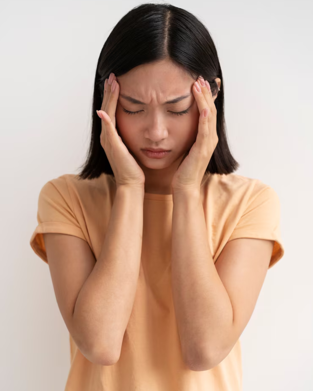 "A young person sitting with their head down, surrounded by emotional thought bubbles showing confusion, sadness, overthinking, and fear – representing anxiety and mood swings."