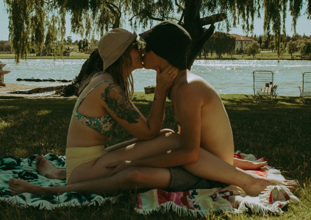 “Couple sharing their first kiss, capturing the nervous excitement and romantic moment of young love.”